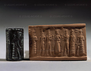 Cylinder seal and imprint, Paleo-Babylonian period. The water-goddess, standing on two goats between two naked heroes. They honour a deity holding a large ring. Haematite, H: 2,25 cm AO 25518