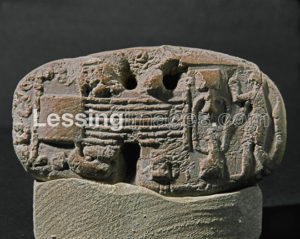 Man at a weaving loom. Tablet with seal imprint. Terracotta relief from Susa, Iran (3300-3000 BCE - Proto-urban Period) 3.9 x 6.6 cm Sb 3048