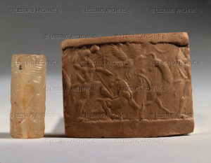 Cylinder seal and imprint, Assyrian, 1st mill.BCE Battle scene, a hero fighting a lion who chases an antelope. Chalcedony, H: 2,8 cm