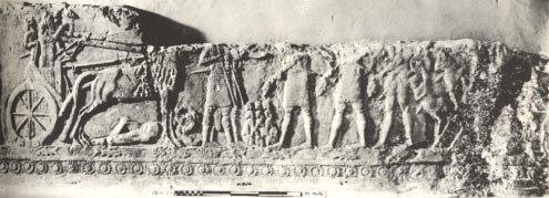 19 - artifact of an Assyrian king in a war scene, counting the heads of the enemy piling up, artifacts like this that do not involve giant alien gods, are made available in musuems for the public's view, the controvercial artifacts are usually hidden away for only the elite acadimic eyes to see, some groups want them hidden away, others want them set aside as myths, but Radical Islam wants them all destroyed, fearing knowledge of them would destroy the Islamic power brokers' hold over its followers