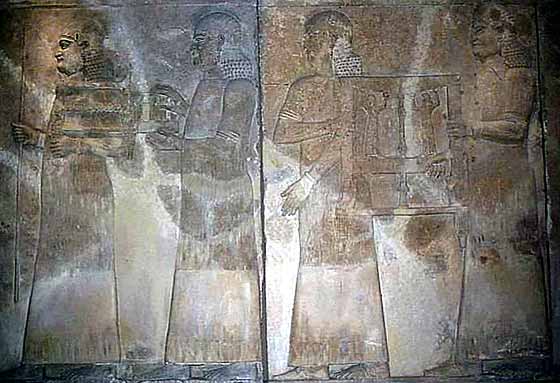 25 - Assyrian wall relief of earthlings attending the king, Khorsabad artifact, artifacts like this that do not involve giant alien gods, are made available in musuems for the public's view, the controvercial artifacts are usually hidden away for only the elite acadimic eyes to see, some groups want them hidden away, others want them set aside as myths, but Radical Islam wants them all destroyed, fearing knowledge of them would destroy the Islamic power brokers'  hold over its followers