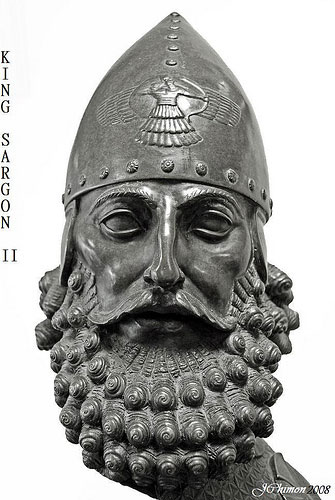 19b - Sargon-II, a semi-divine descendant of the gods, making him taller, stronger, faster, & smarter than other earthlings, a perfect go-between for the gods & man, his patron god Ashur flying protection from above engraved onto his helmet