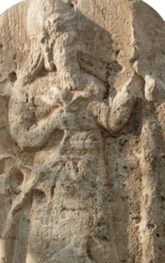 2 - stele of Adad with poppy & a staff in his hands, & crown of animal horns upon his head, a symbol of Anunnaki royalty