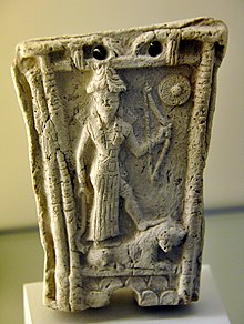 5bb - Goddess Ishtar stands on a lion and holds a bow, Shamash symbol at the upper right corner