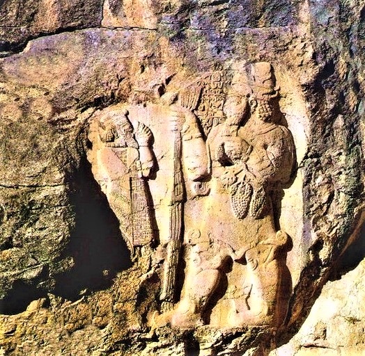 5d - rock relief of smaller semi-divine Assyrian king, & his giant god Adad